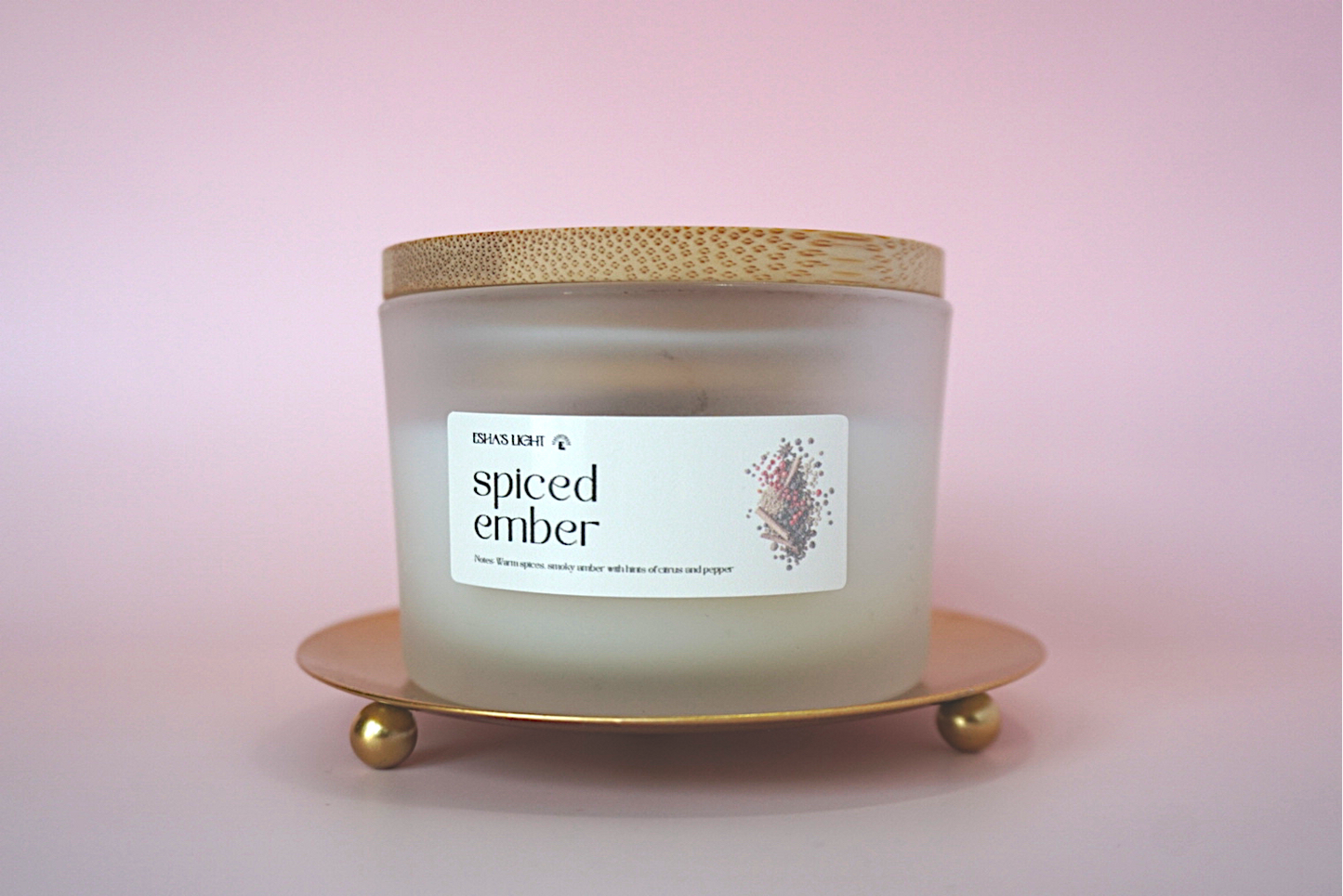 hand-poured warm spiced soy candle in frosted glass jar